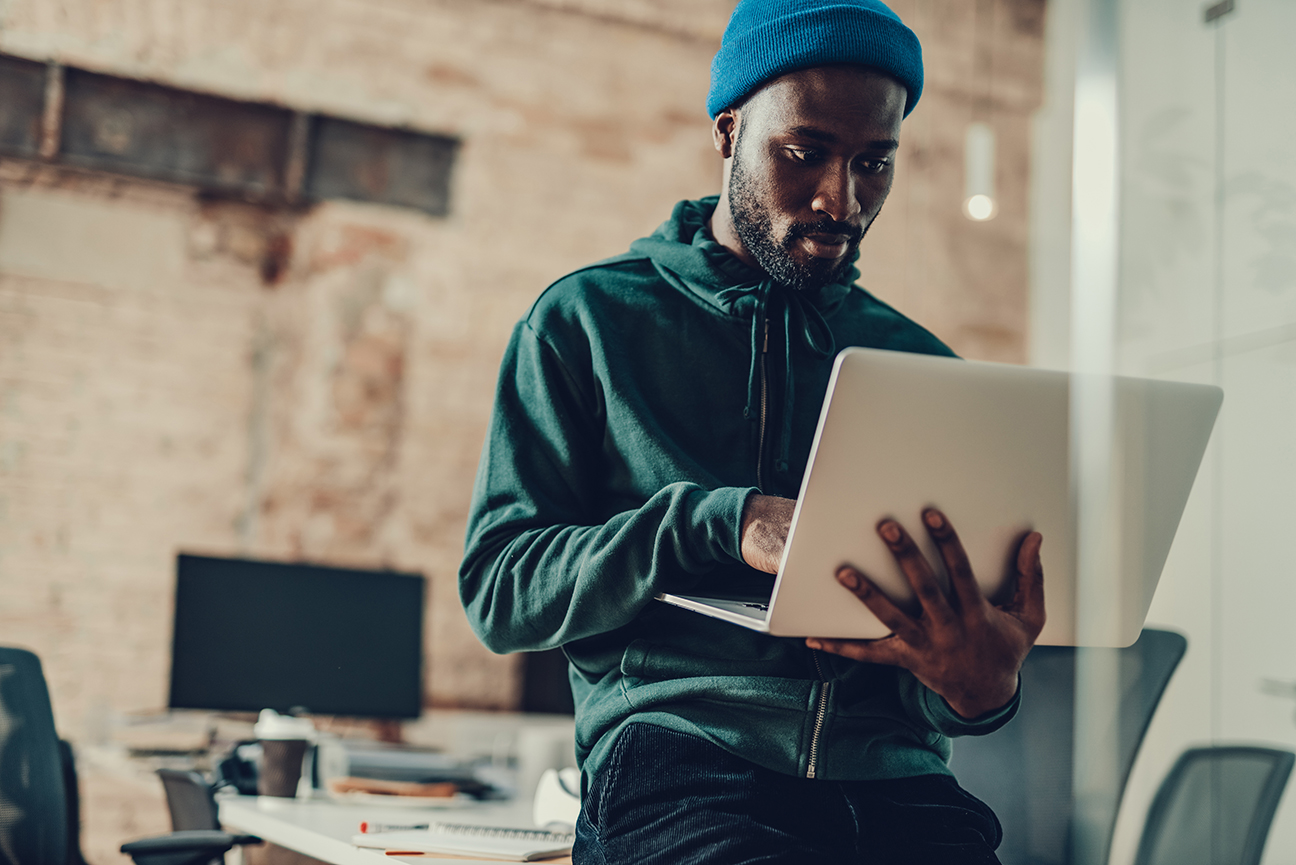 Man working on a laptop in a modern office space